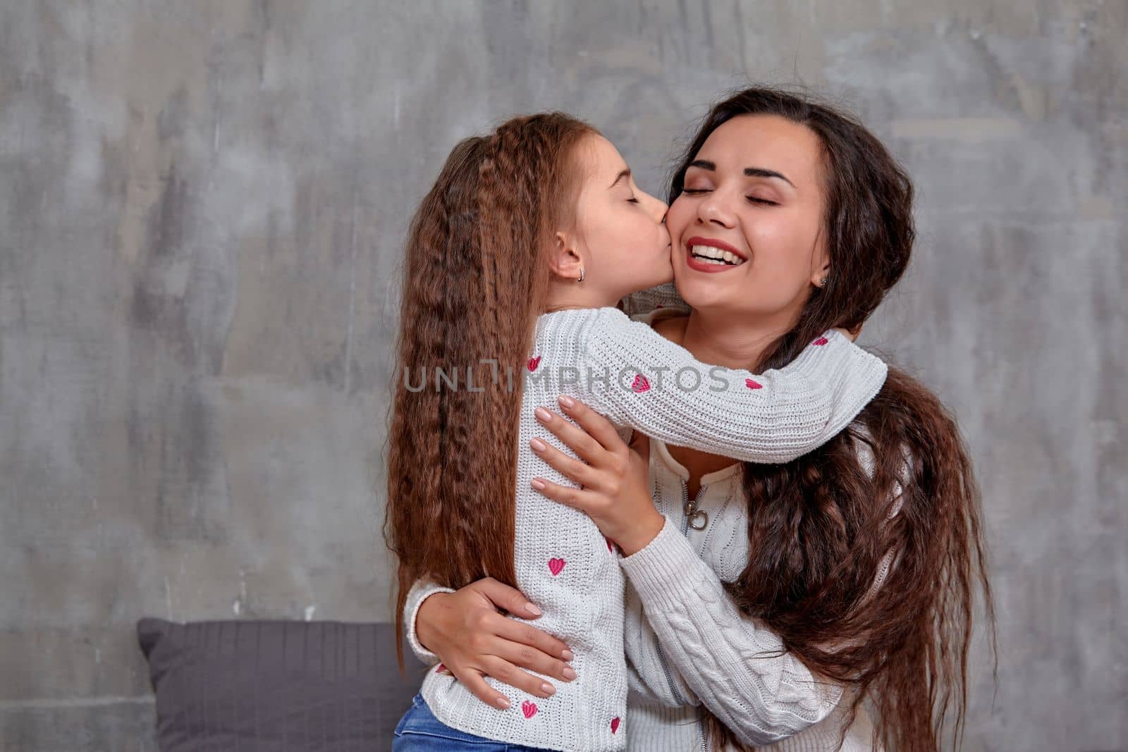 Emotions of a young beautiful mother and her little daughter who spend time together. They show love for each other