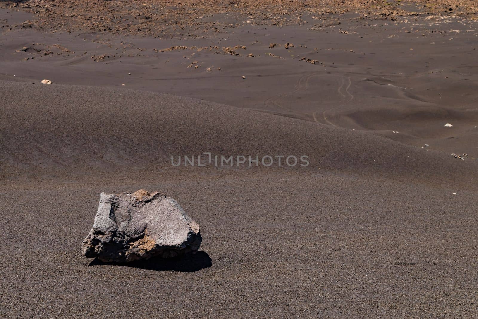 Slope with lava, ash and a large boulder at the volcano Pico do Fogo on the island Fogo, Cape Verde Islands