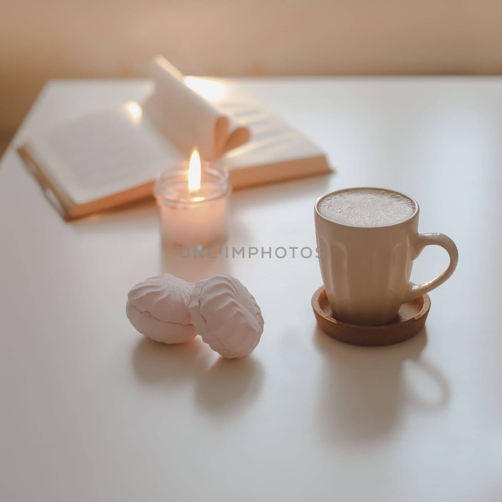 coffee cup, cotton flower, open book on a white table background top view. minimal home interior decor. 
