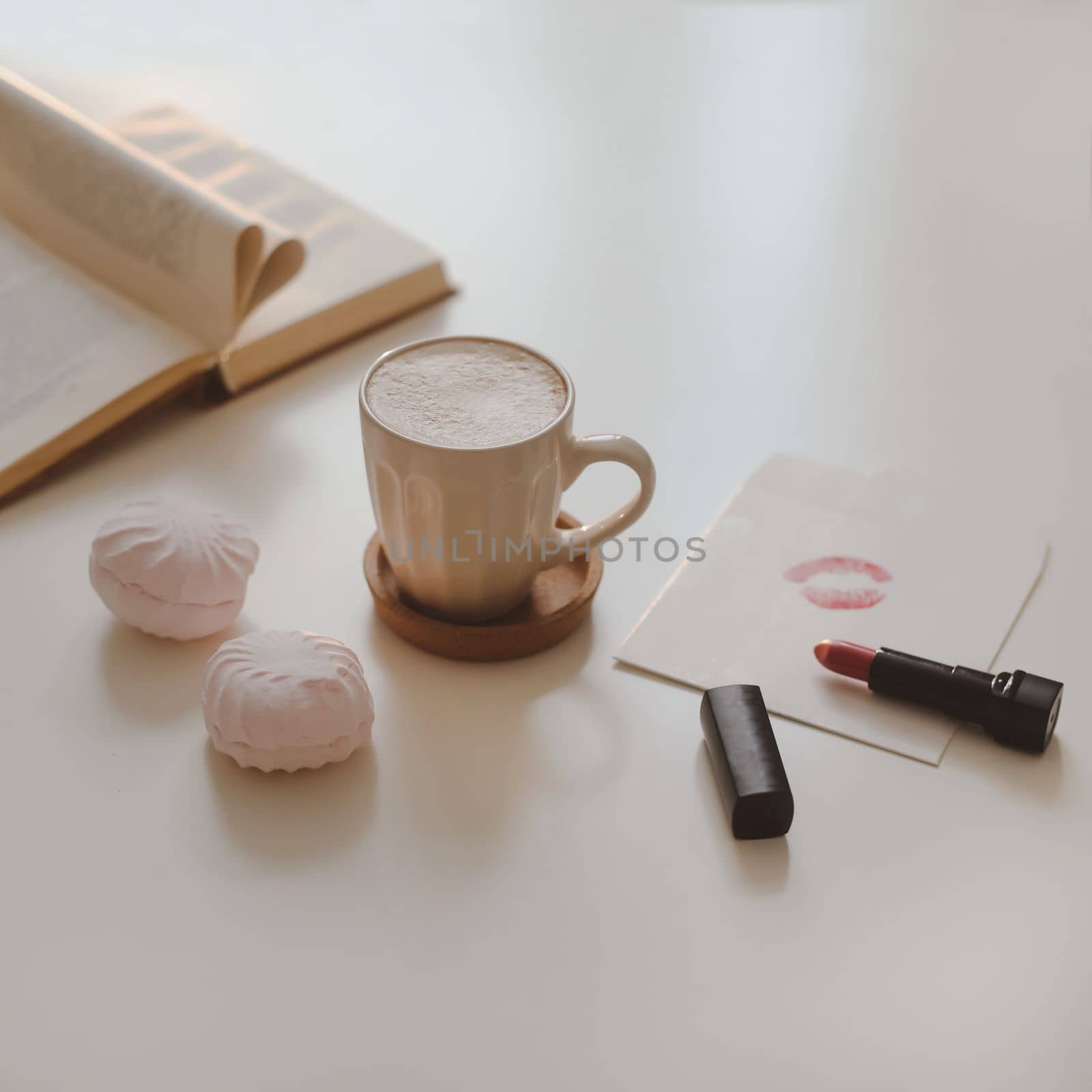 coffee cup, flower, candle and a book on a white table background top view by paralisart