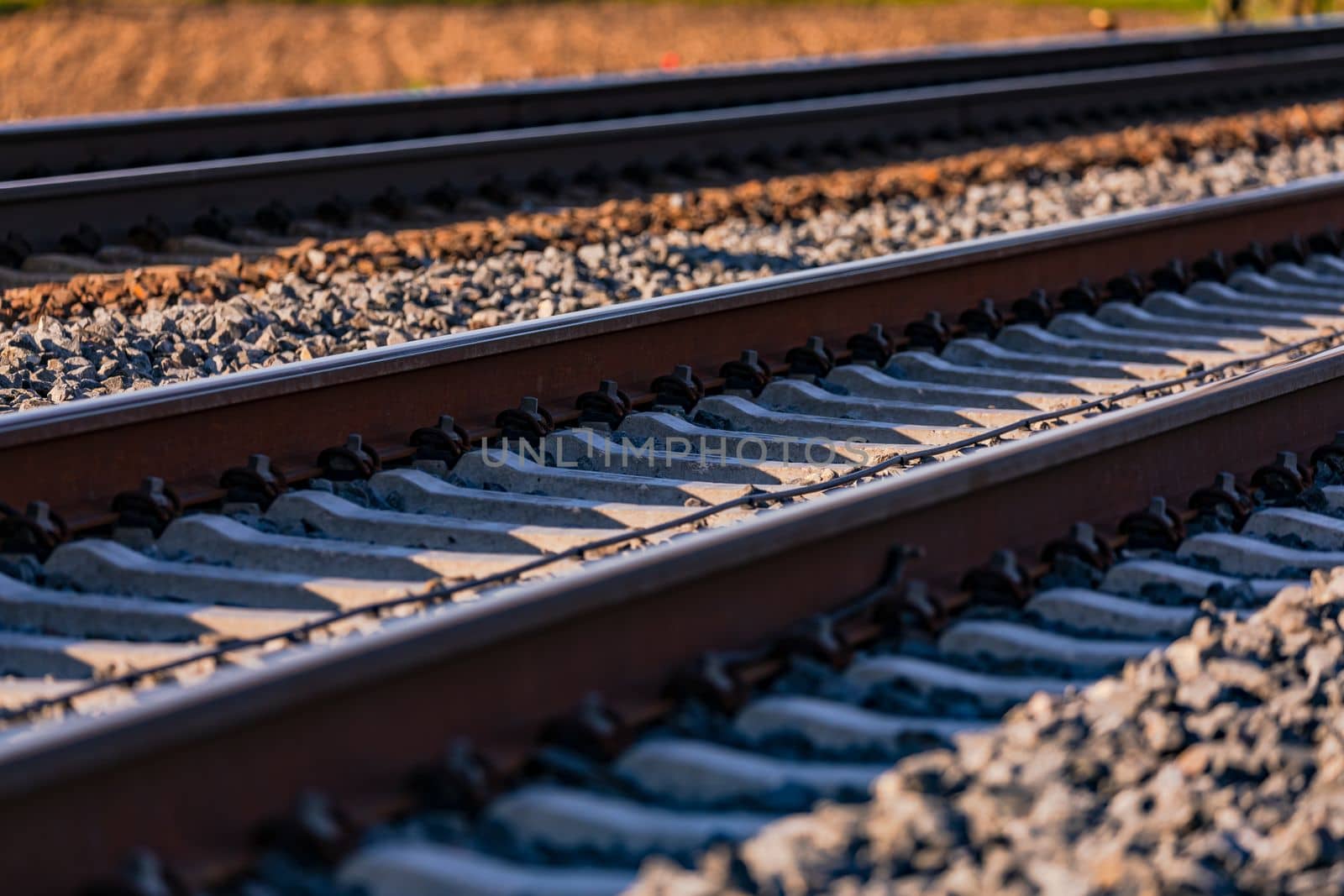 Sleepers and rails with screws in the track bed with ballast