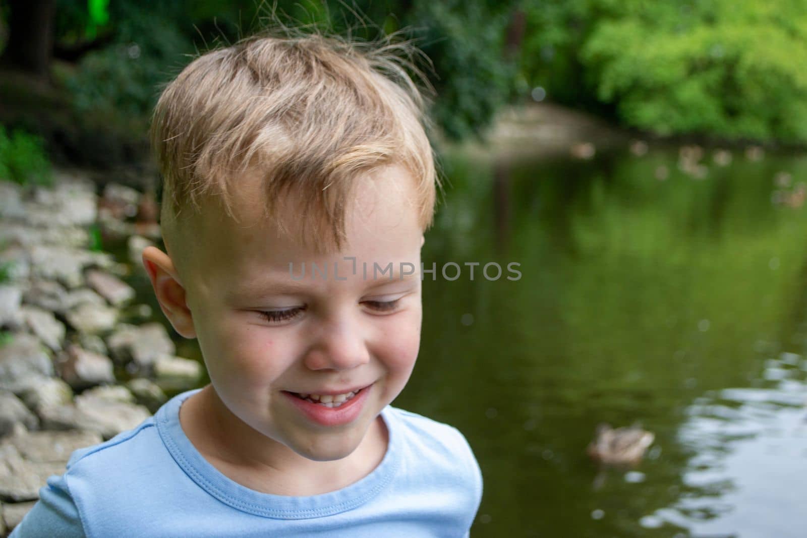 Close-up Of The Face Of A Beautiful 5 Year Old Boy Lying On The Bed by milastokerpro