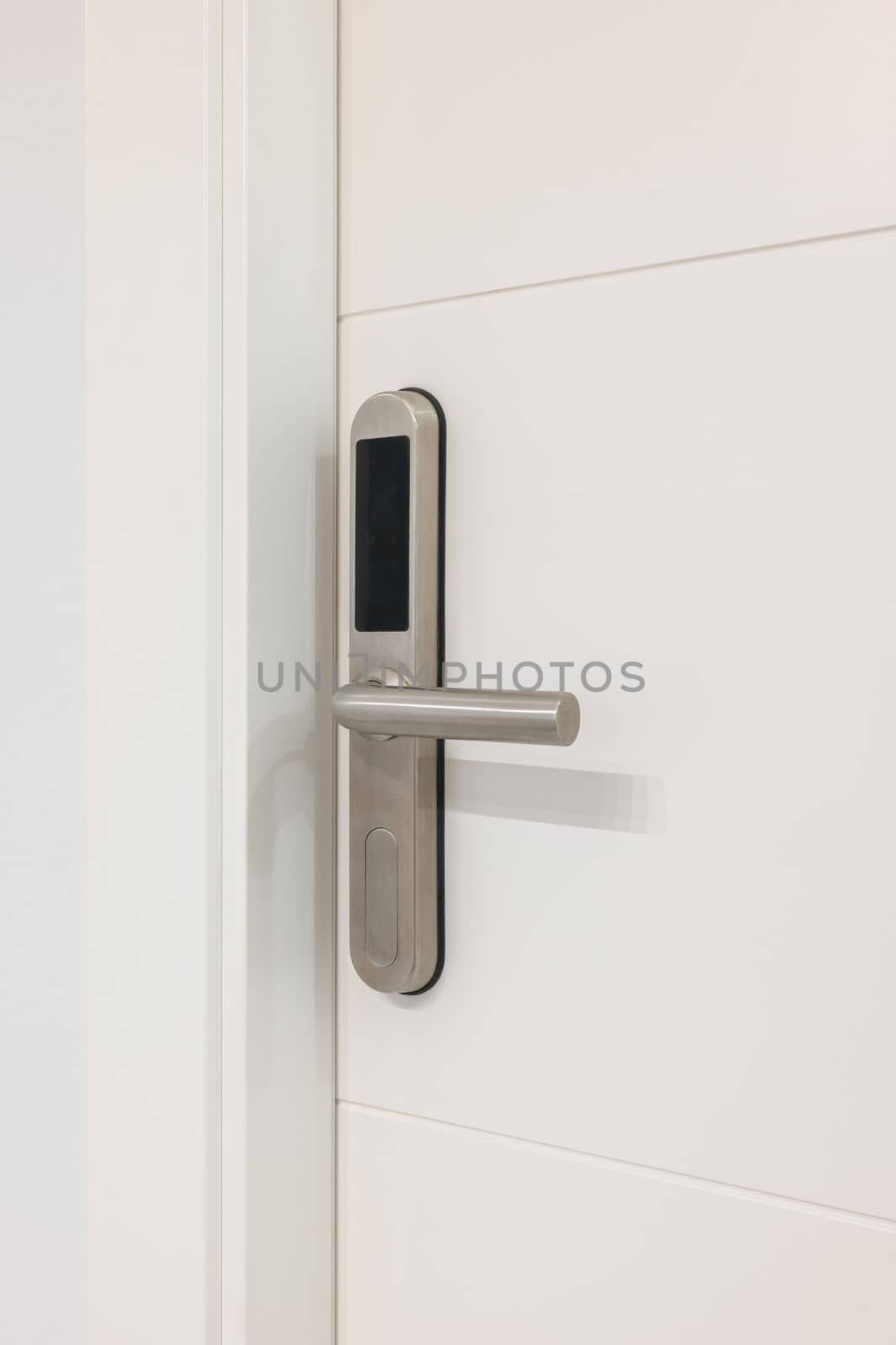 Door handle with plastic card with microchip or digital code. Closeup of an entrance white door with an electronic mortise lock
