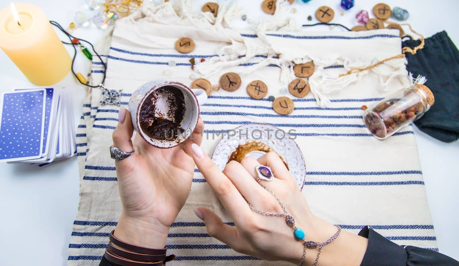 A fortune teller reads fortunes on coffee grounds. Selective focus. Woman.