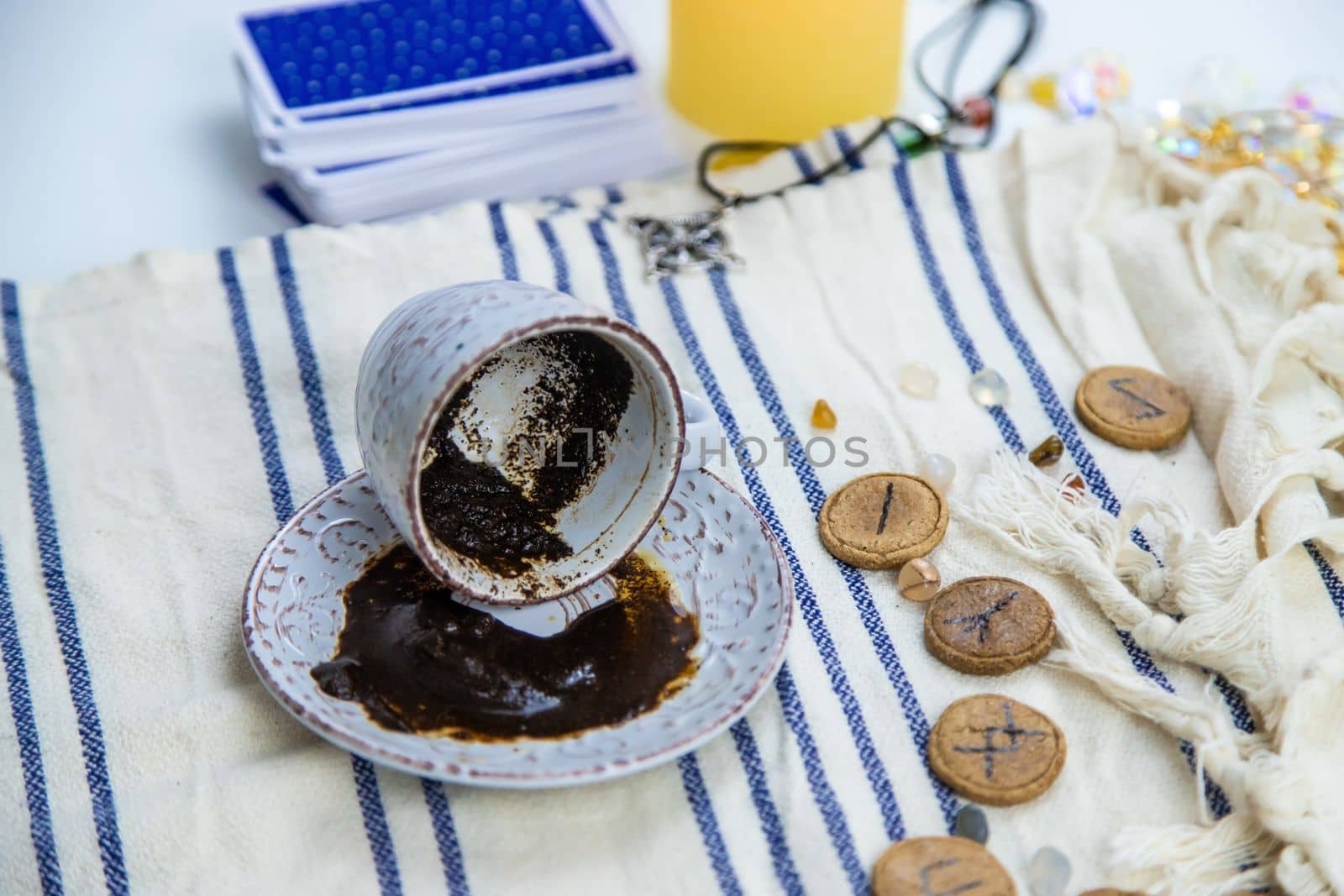 A fortune teller reads fortunes on coffee grounds. Selective focus. Woman.
