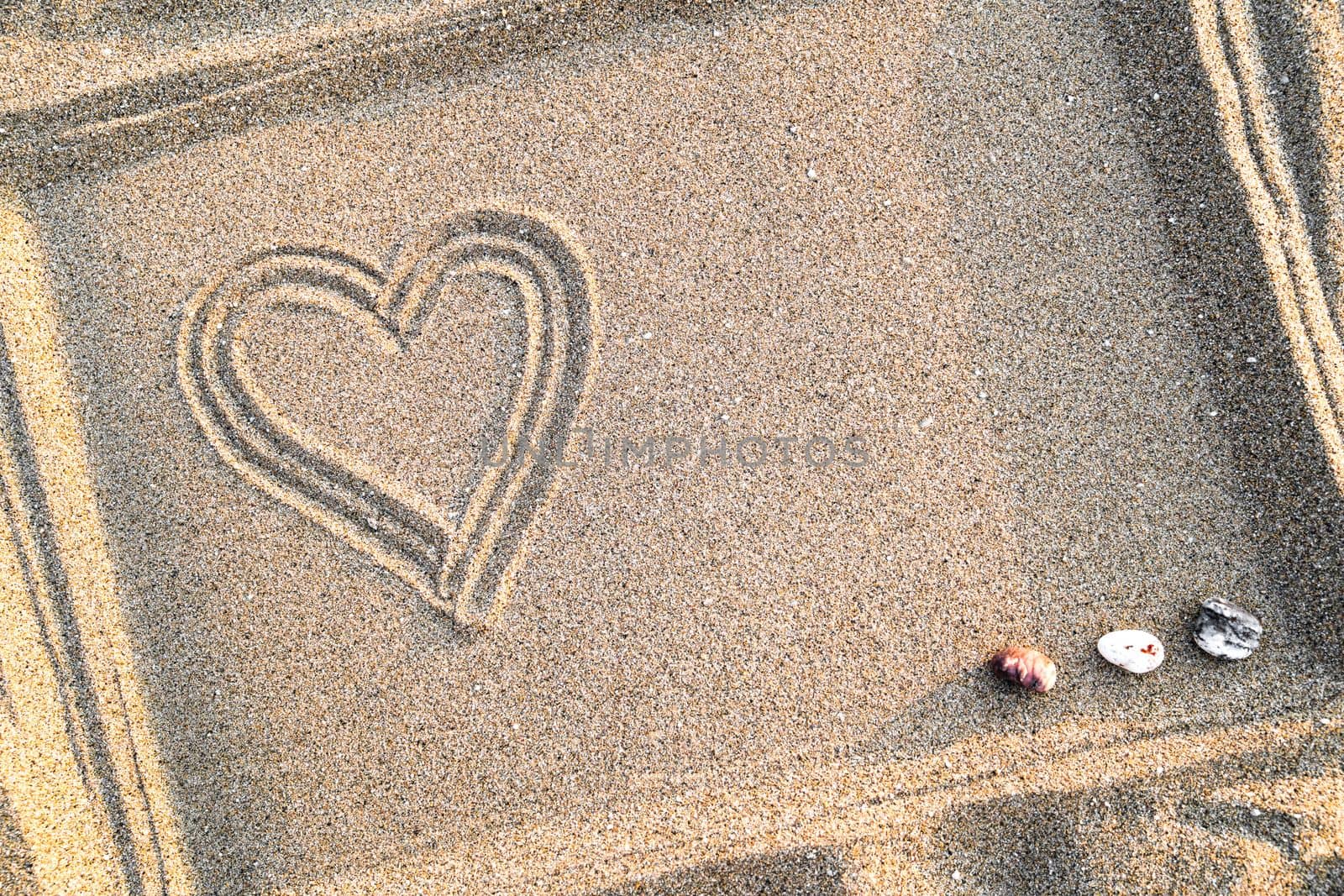 Heart drawn on sand in frame, concept of love and health, top view, close-up, copy space  by Laguna781