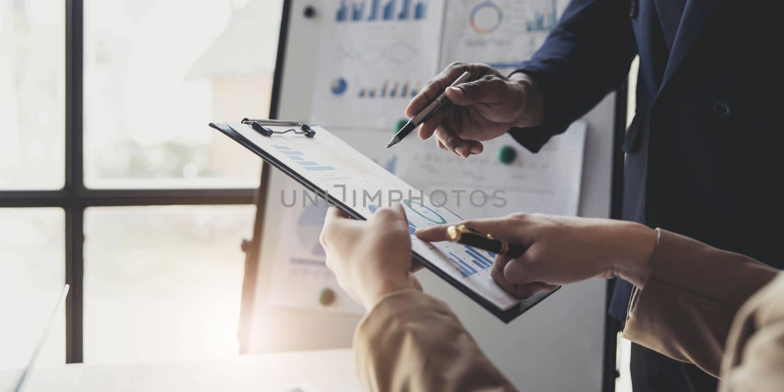 Business People Meeting using laptop computer,calculator,notebook,stock market chart paper for analysis Plans to improve quality next month. Conference Discussion Corporate Concept. by wichayada