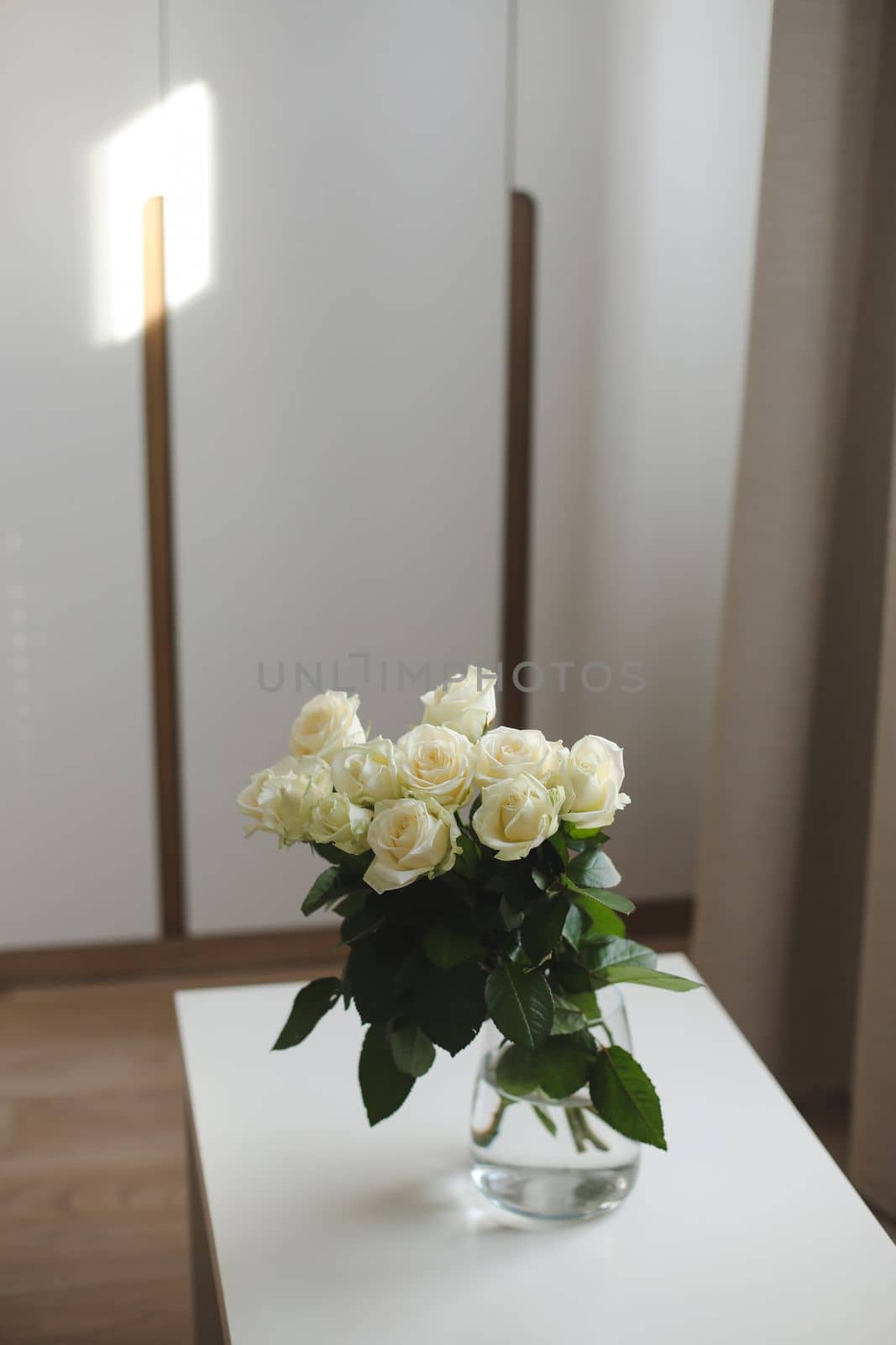 White rose bouquet in a cozy home interior. Floral spring or Valentines day romantic background, happy holiday on February 14, dating and love concept