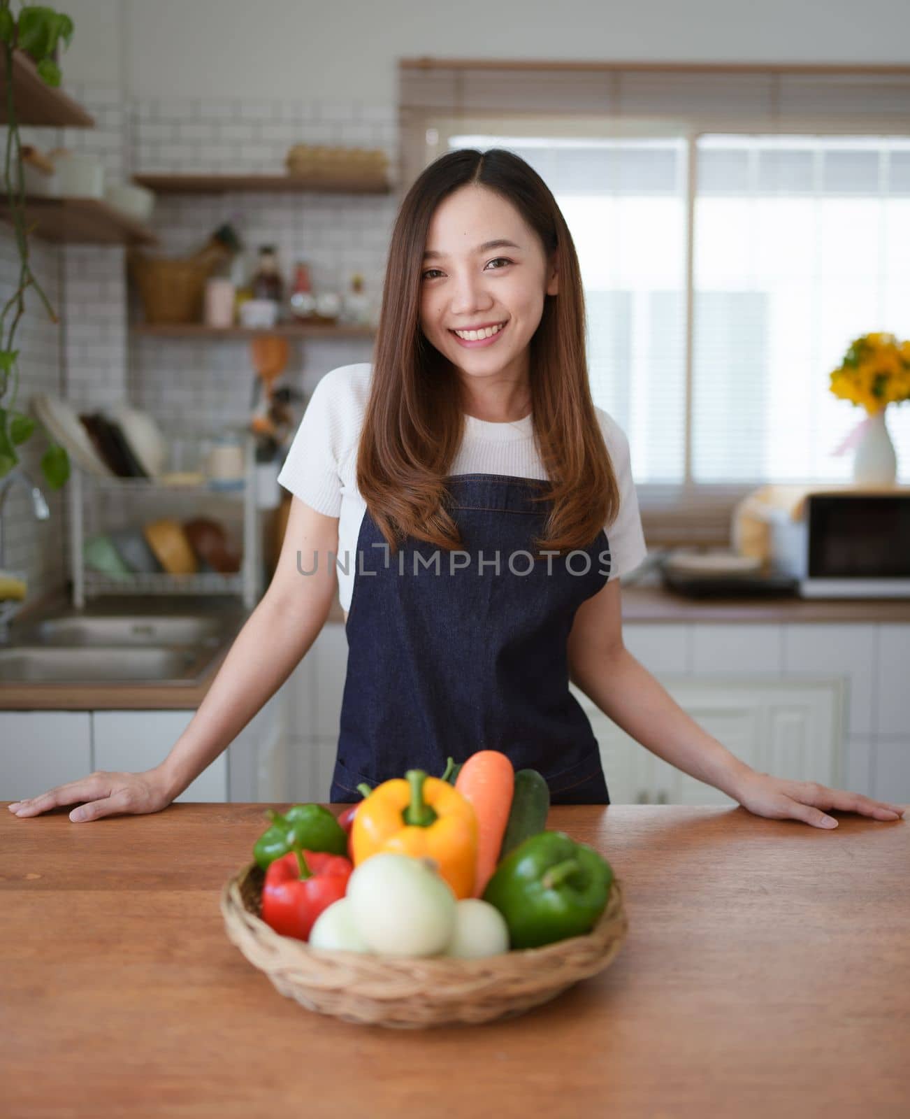 Portrait of beautiful young asian woman making salad at home. cooking food and Lifestyle moment.