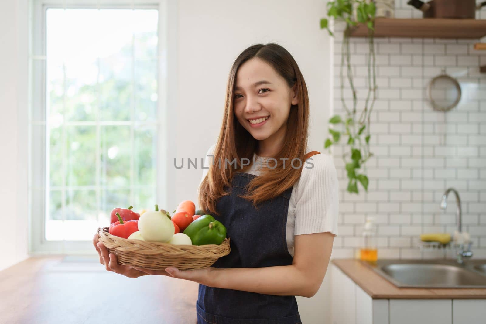 Portrait of beautiful young asian woman making salad at home. cooking food and Lifestyle moment by itchaznong