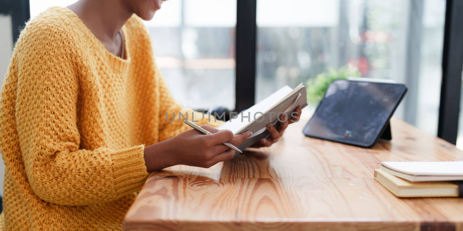 Young black curly hair American African woman using digital tablet.