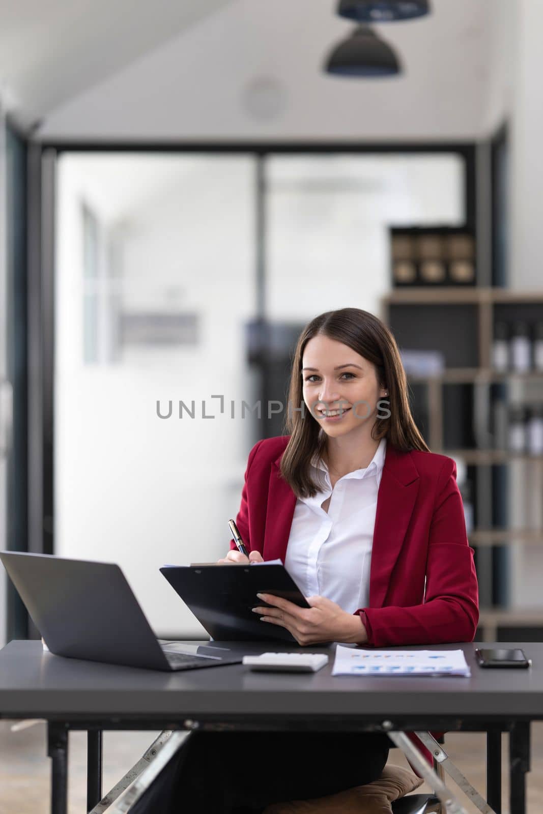 Business woman using calculator for do math finance on wooden desk in office and business working