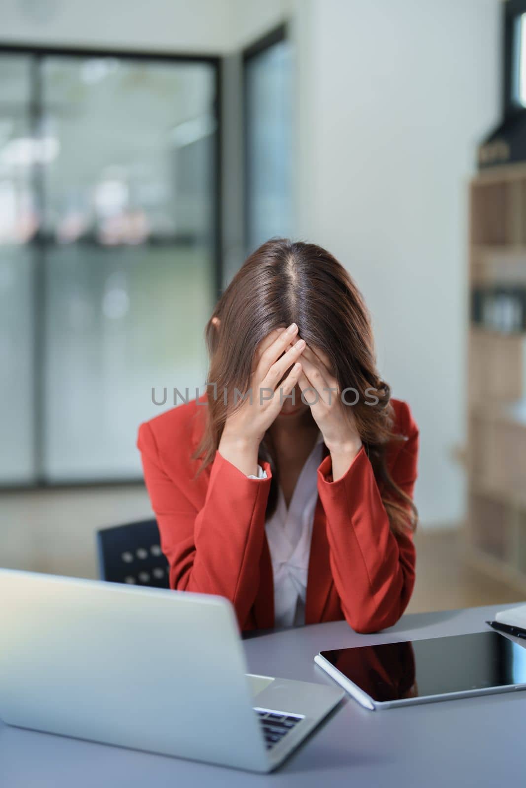 Portrait of sme business owner, woman using computer and financial statements Anxious expression on expanding the market to increase the ability to invest in business by Manastrong