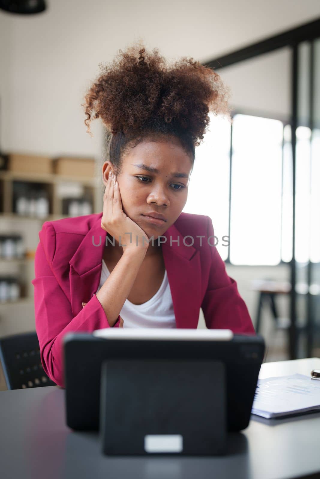 Portrait thoughtful confused young african american businesswoman looking at laptop. Stress while reading news, report or email. Online problem, finance mistake, troubleshooting by itchaznong