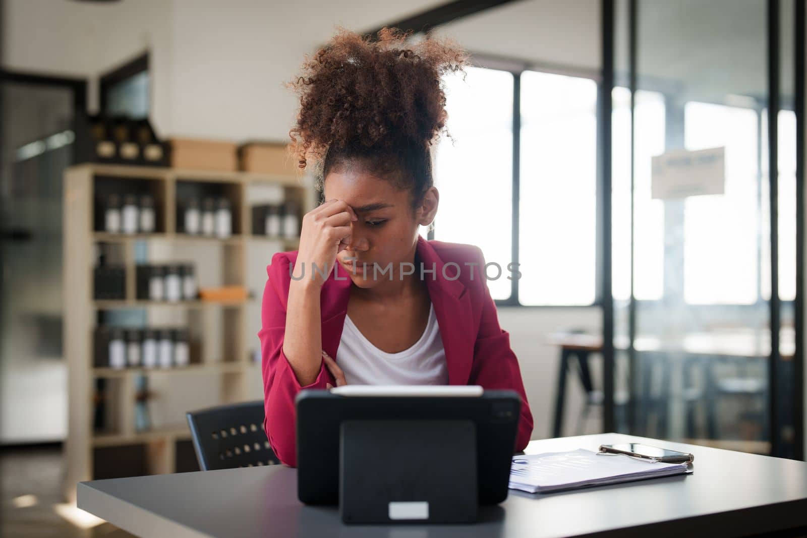 Portrait thoughtful confused young african american businesswoman looking at laptop. Stress while reading news, report or email. Online problem, finance mistake, troubleshooting.