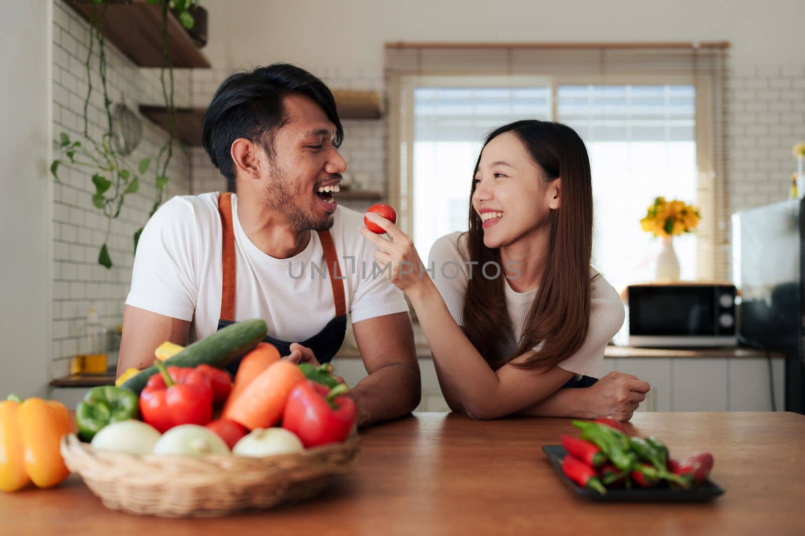 Portrait of young asian couple making salad together at home. cooking food and Lifestyle moment and healthy by itchaznong