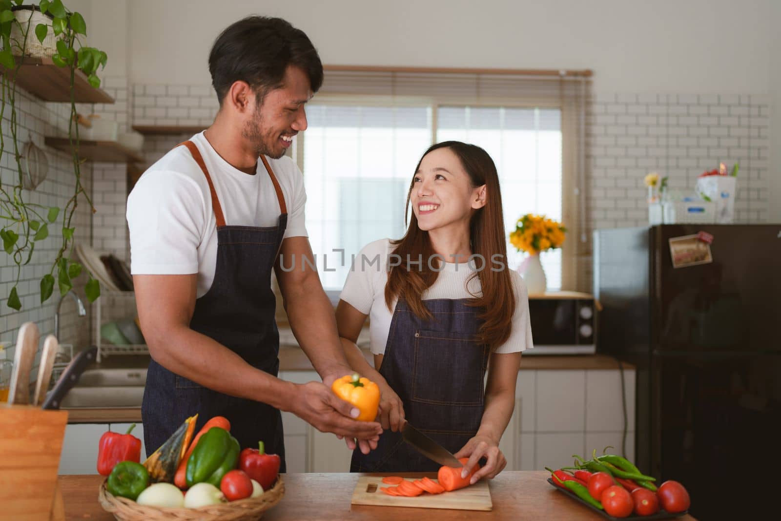 Portrait of young asian couple making salad together at home. cooking food and Lifestyle moment and healthy.