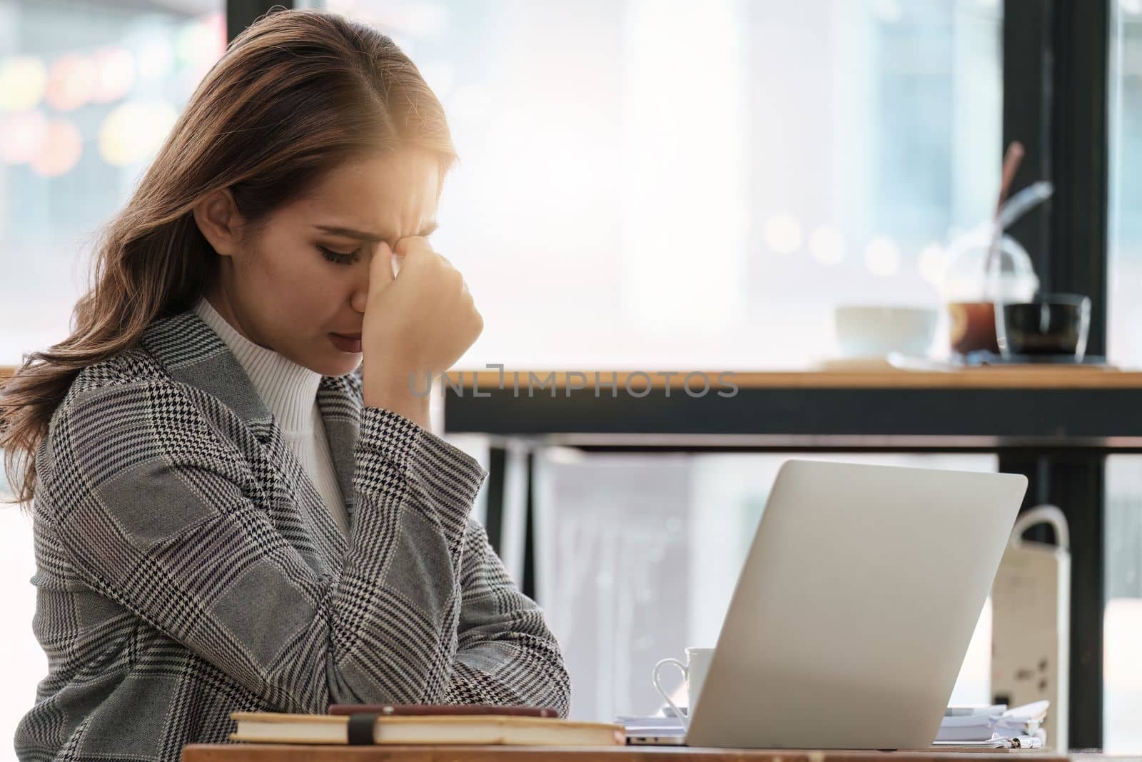 Portrait thoughtful confused young asian businesswoman looking at laptop. Stress while reading news, report or email. Online problem, finance mistake, troubleshooting.