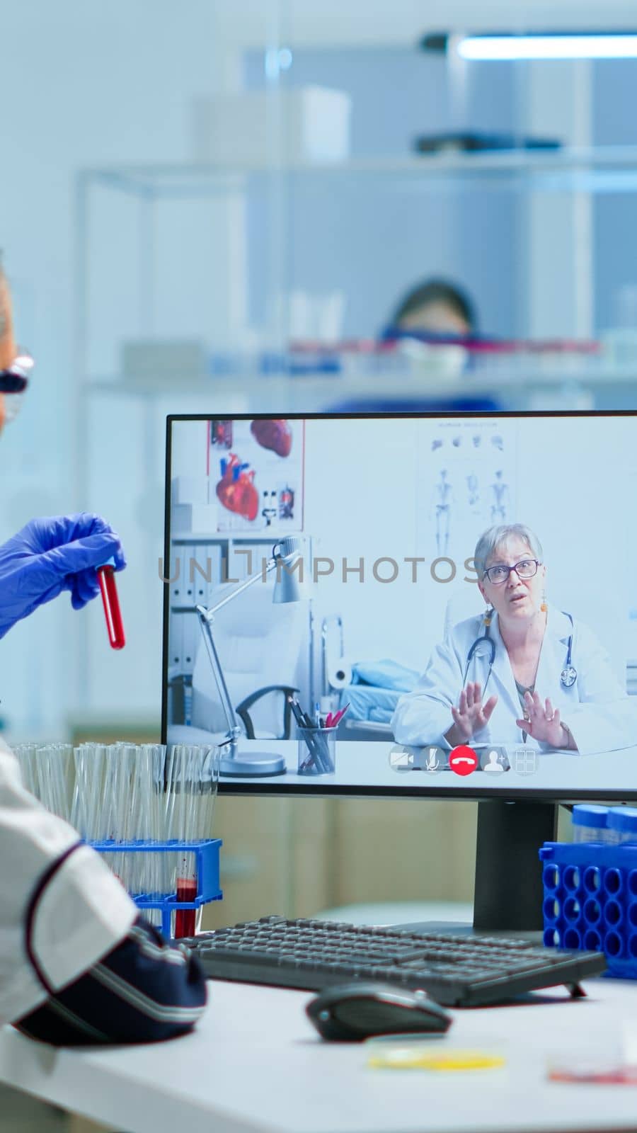 Scientist listening professional doctor on video call by DCStudio