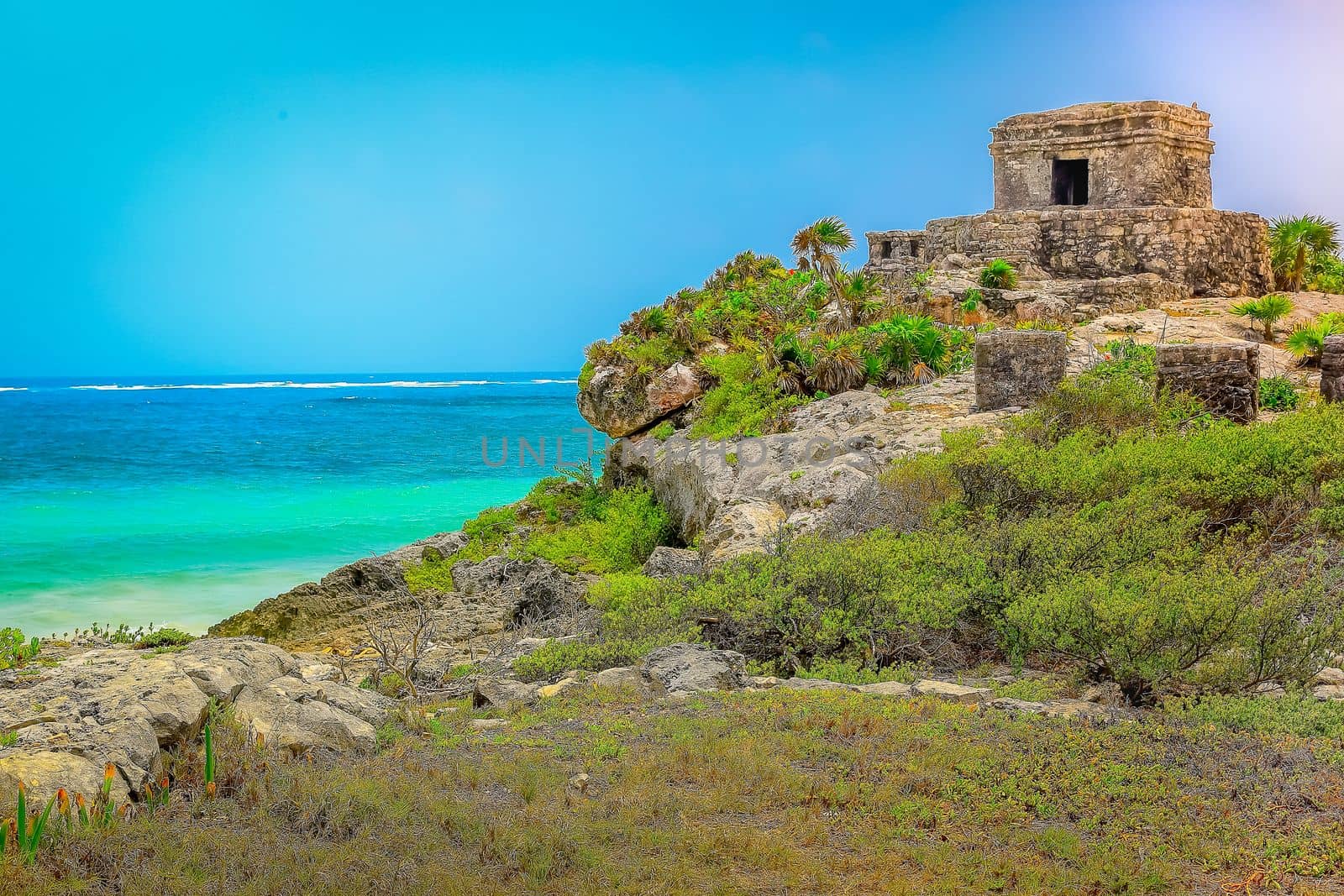 Tropical paradise, sand beach in caribbean with palapa and pier at sunset, Cancun, Mexico