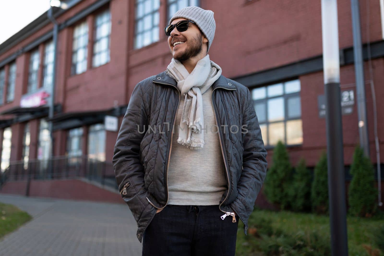 stylish man in sunglasses and hat outside by TRMK