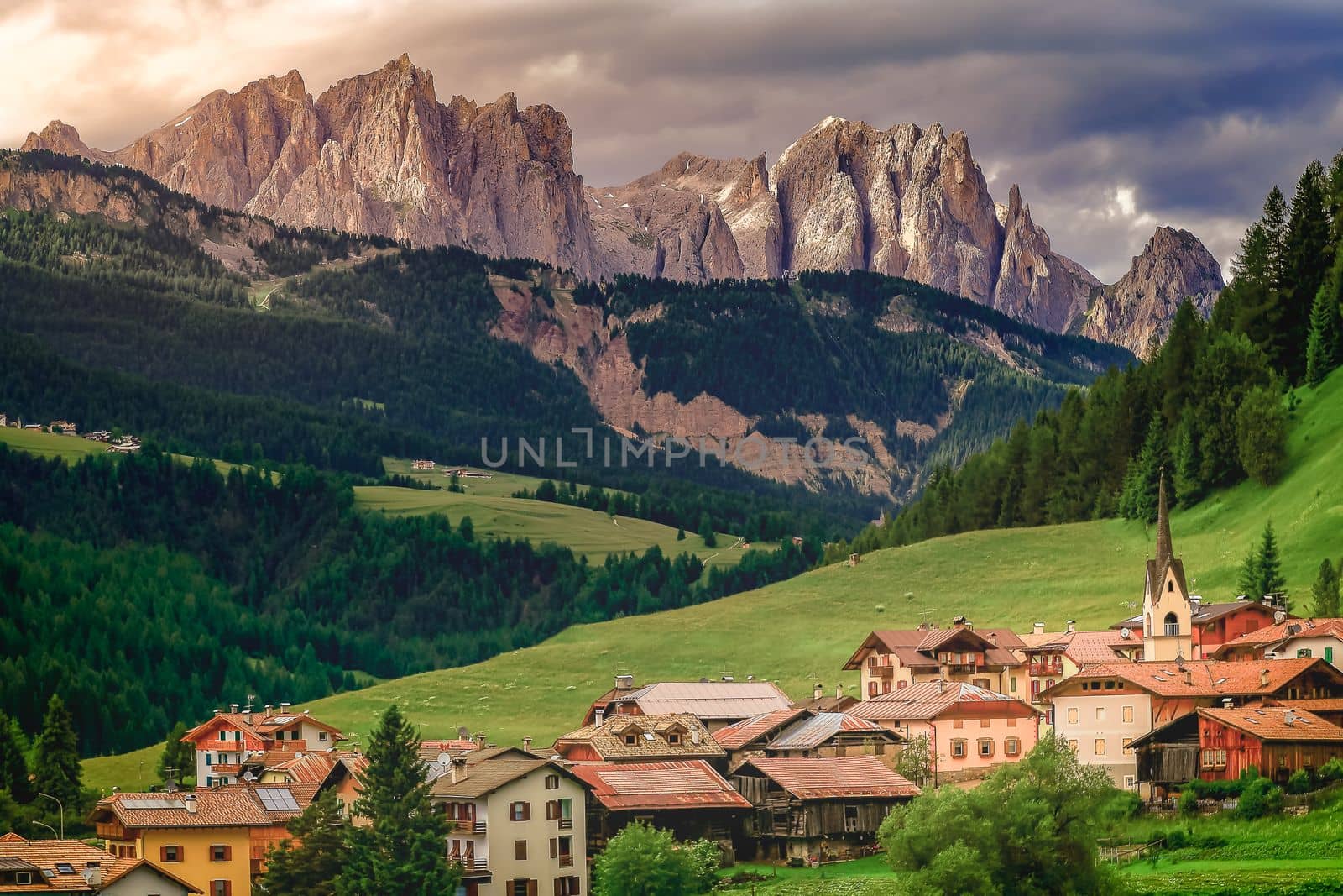 Langkofel and alpine village, Sassolungo pinnacles, Dolomites sudtirol, Pordoi Pass near Cortina d Ampezzo, Italy