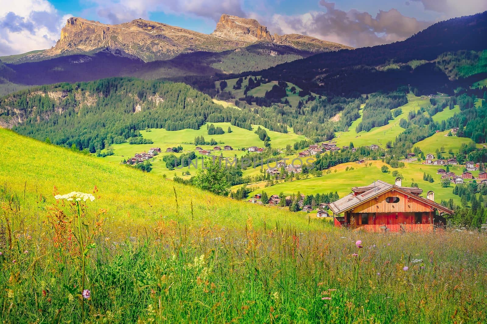 Langkofel and alpine village, Sassolungo pinnacles, Dolomites sudtirol, near Cortina d Ampezzo, Italy