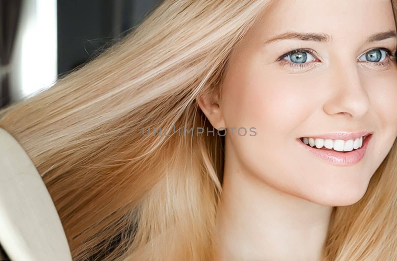 Beautiful happy woman combing her long blond hair by Anneleven