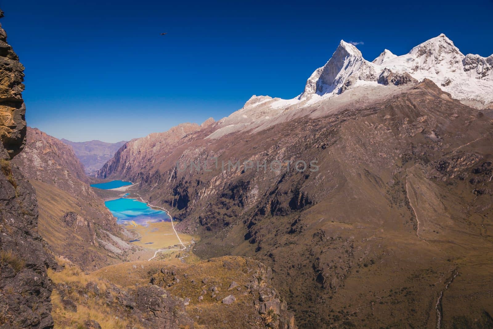 Turquoise Llanganuco lake in Cordillera Blanca at sunny day, snowcapped Andes, Ancash, Peru