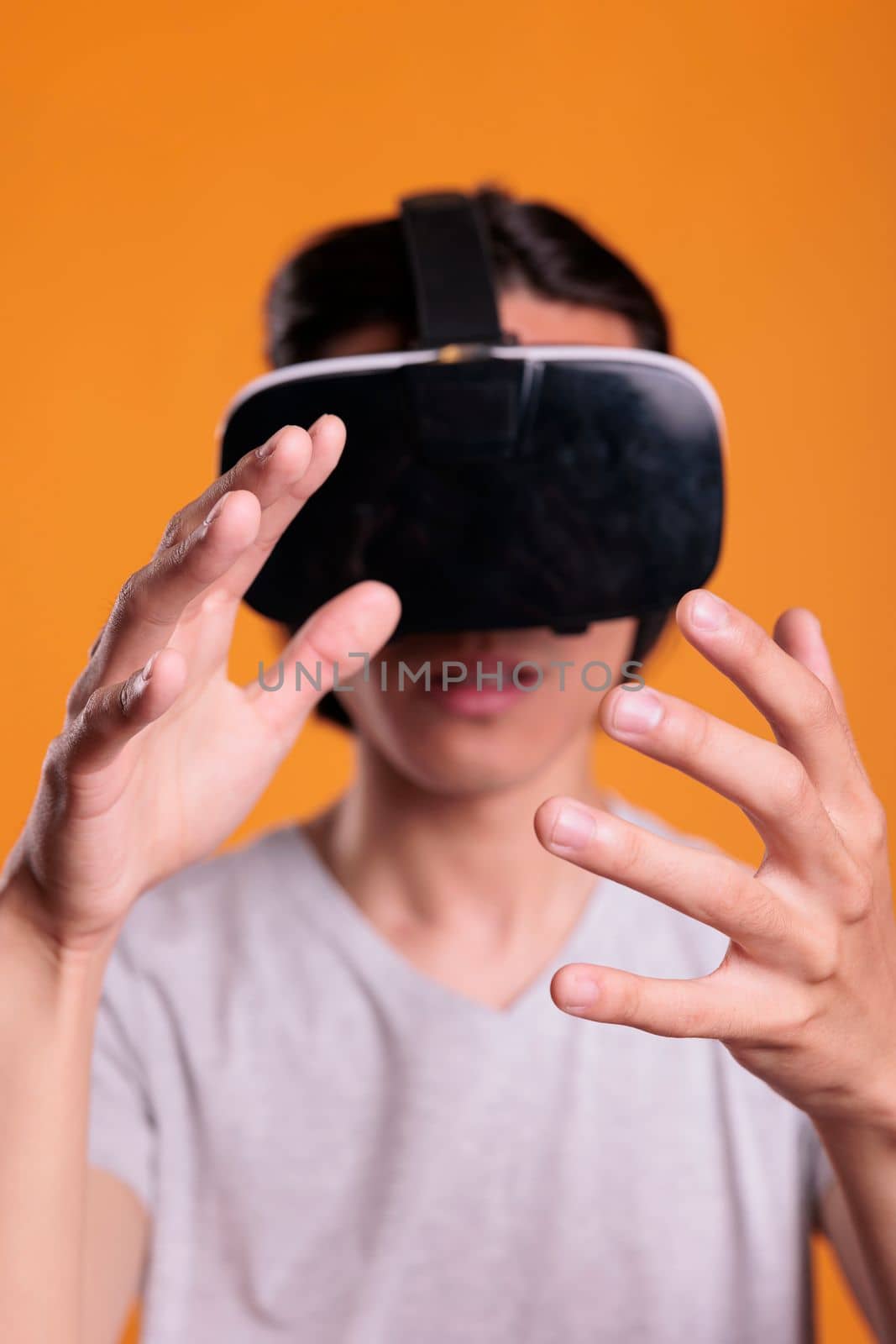 Gamer wearing vr headset playing virtual reality games, exploring metaverse close view, focus on hands. Person in ar goggles enjoying simulation experience, cyberspace entertainment