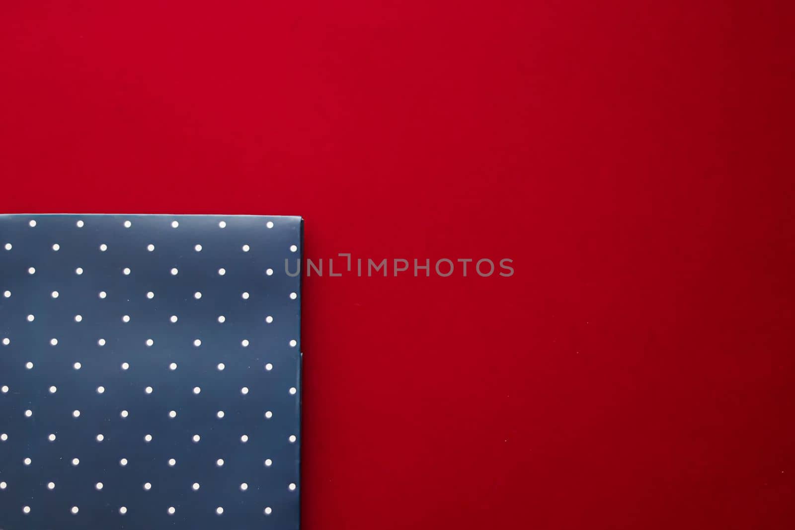 Abstract blue polka dot background on red backdrop.