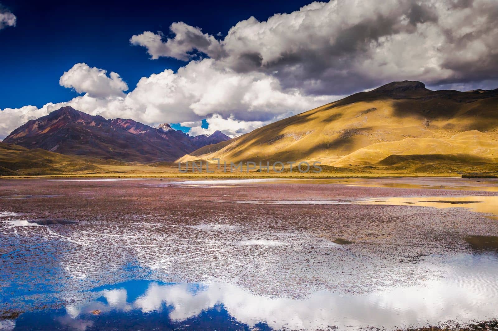 Turquoise lake with mirrored reflection in Cordillera Blanca, snowcapped Andes, Ancash, Peru