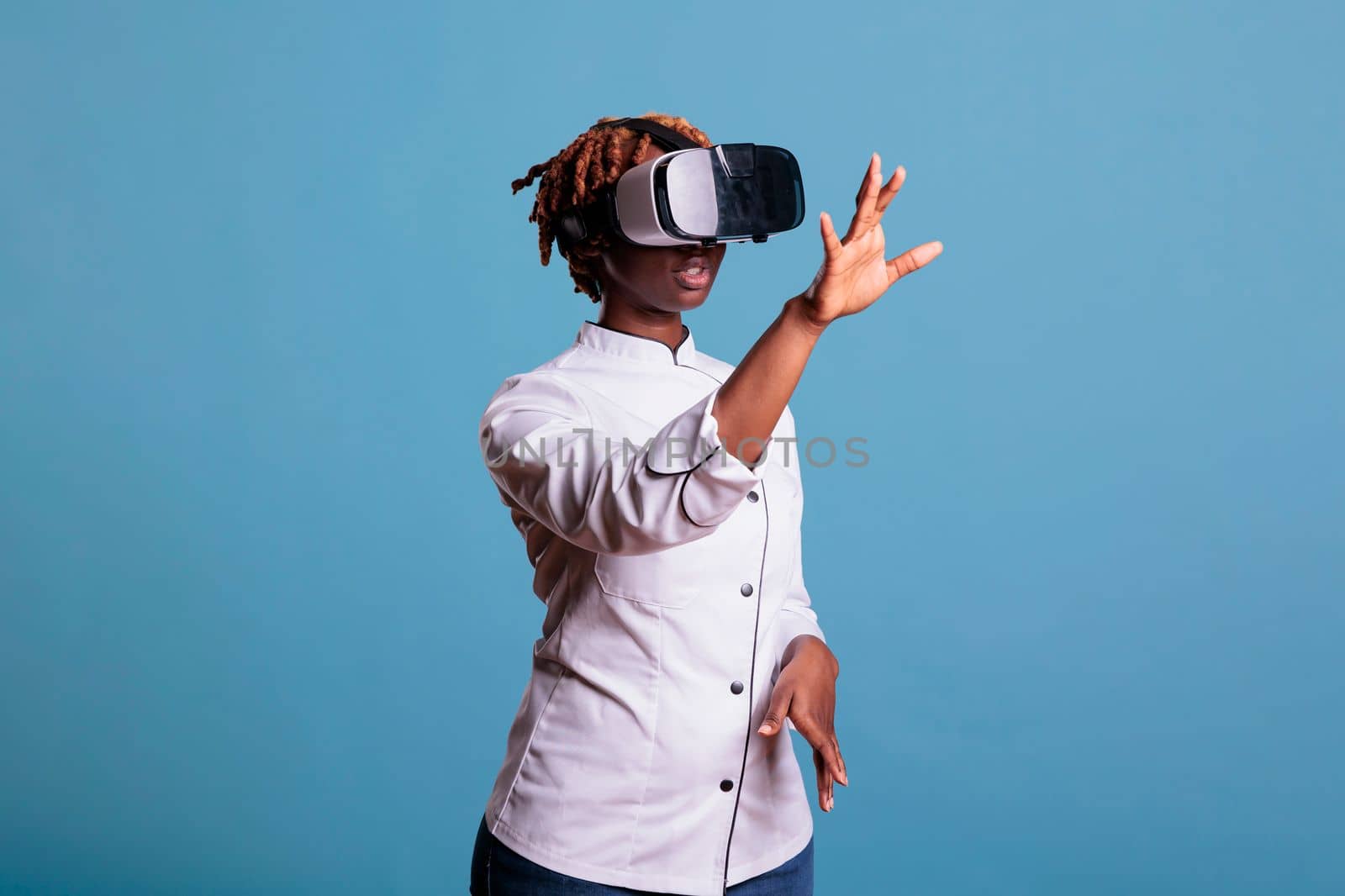 African american girl restaurant worker wearing virtual reality goggles by DCStudio