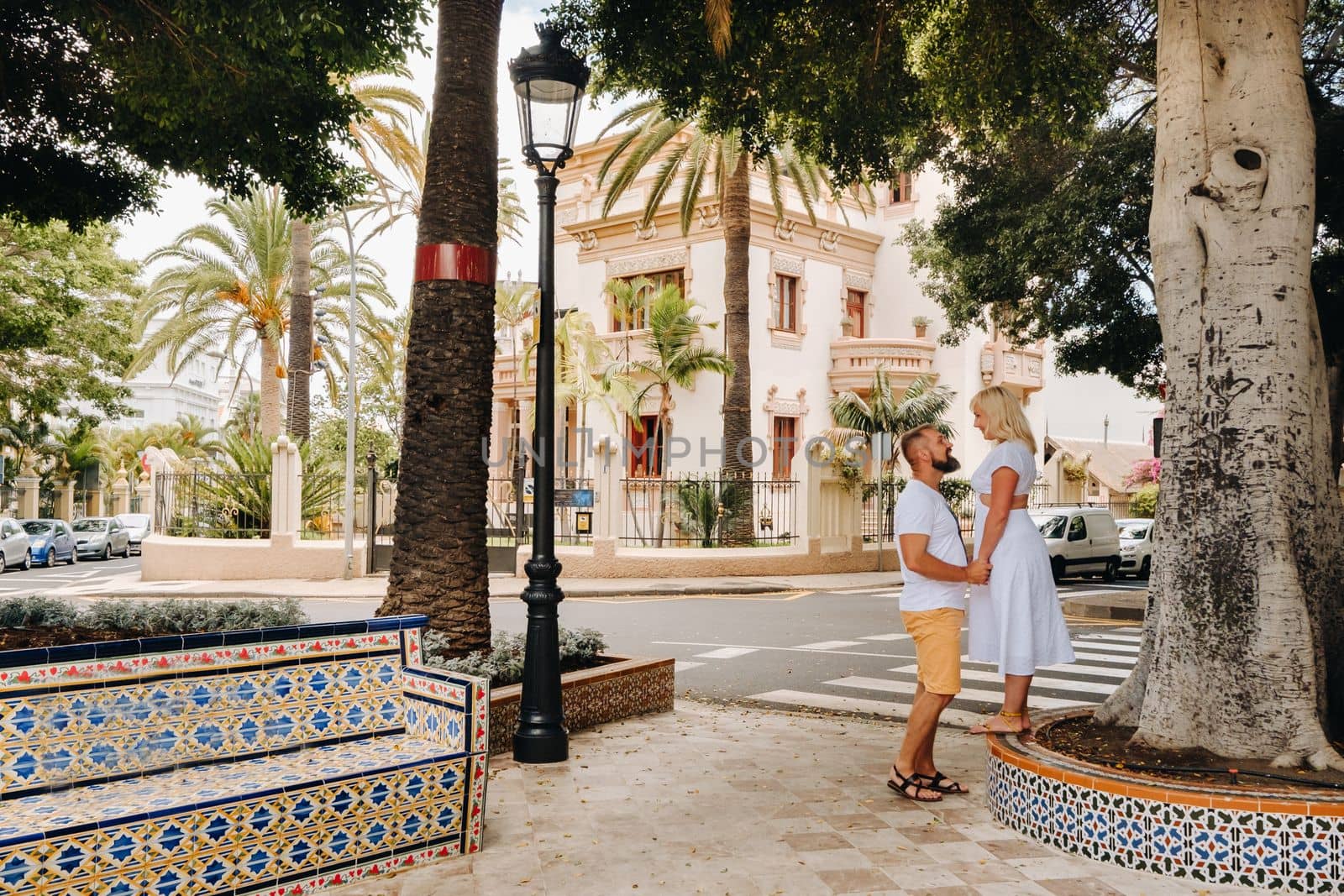 A couple in love stands in the city of Santa Cruz on the island of Tenerife, Canary Islands, Spain by Lobachad