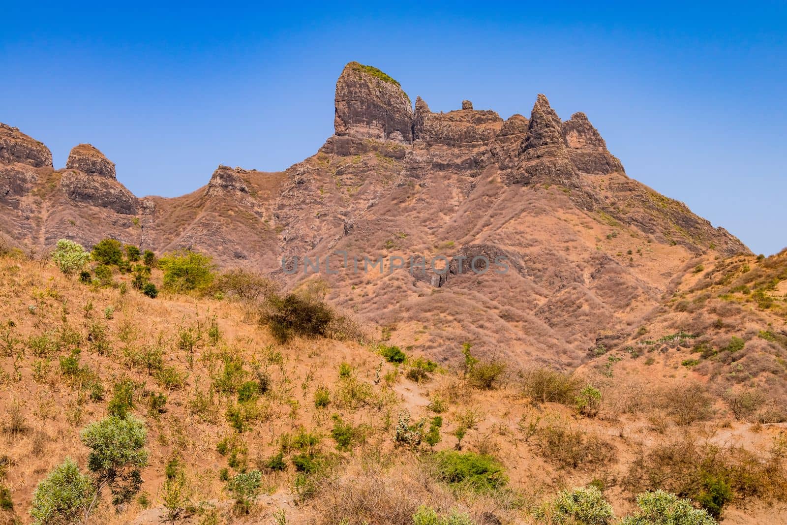 A striking mountain formation with rocks, grasses and shrubs in the center of Santiago Island, Cabo Verde