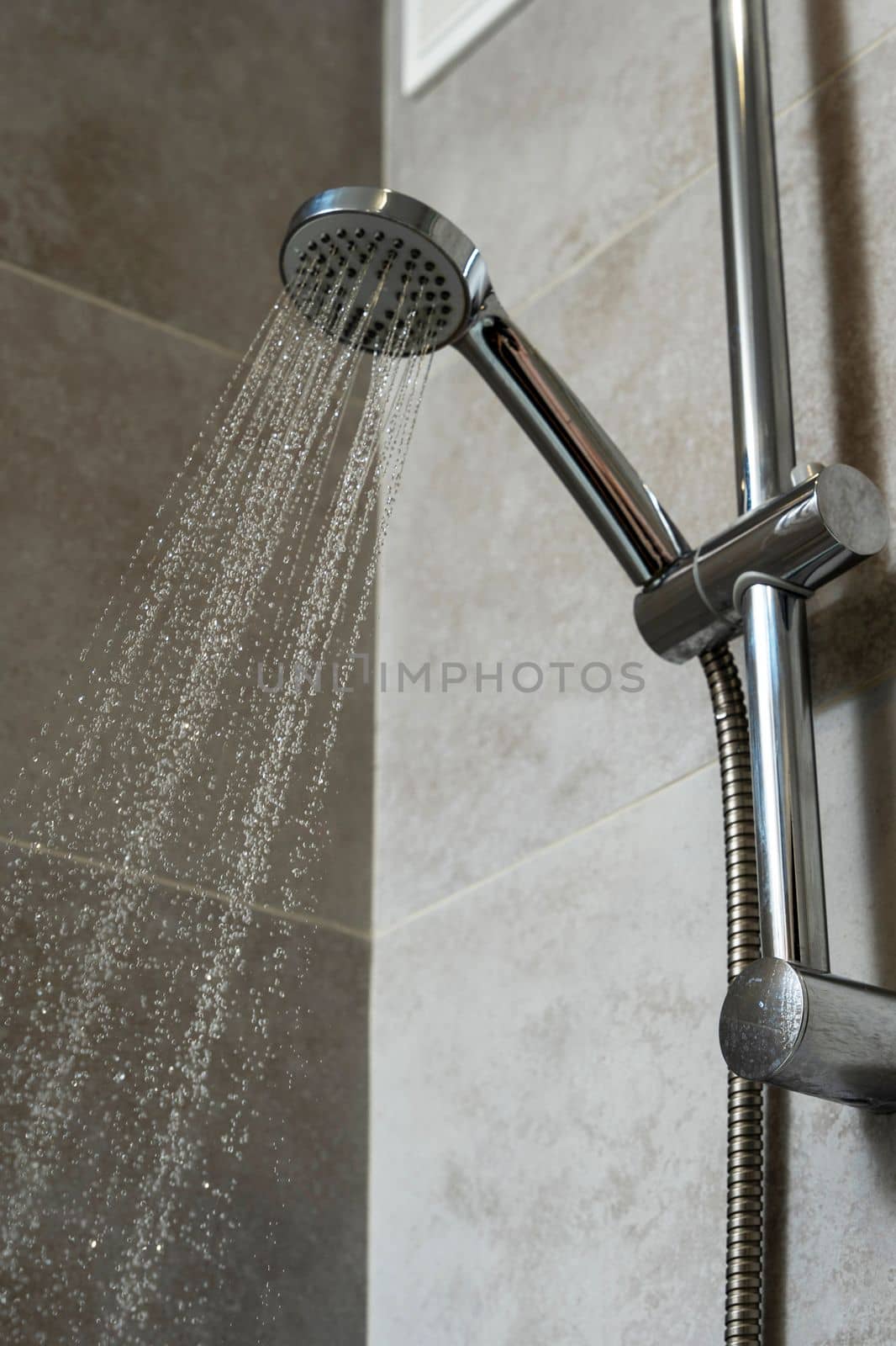 water pours from the shower head. shower-bath. Close up of Water flowing from shower in the bathroom interior. High quality photo