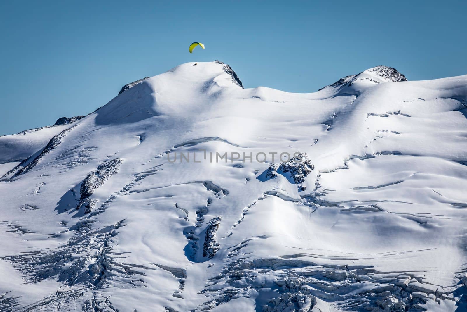 Paragliding above Bernina and Palu mountain range with glaciers in the Swiss Alps, Engadine, Switzerland