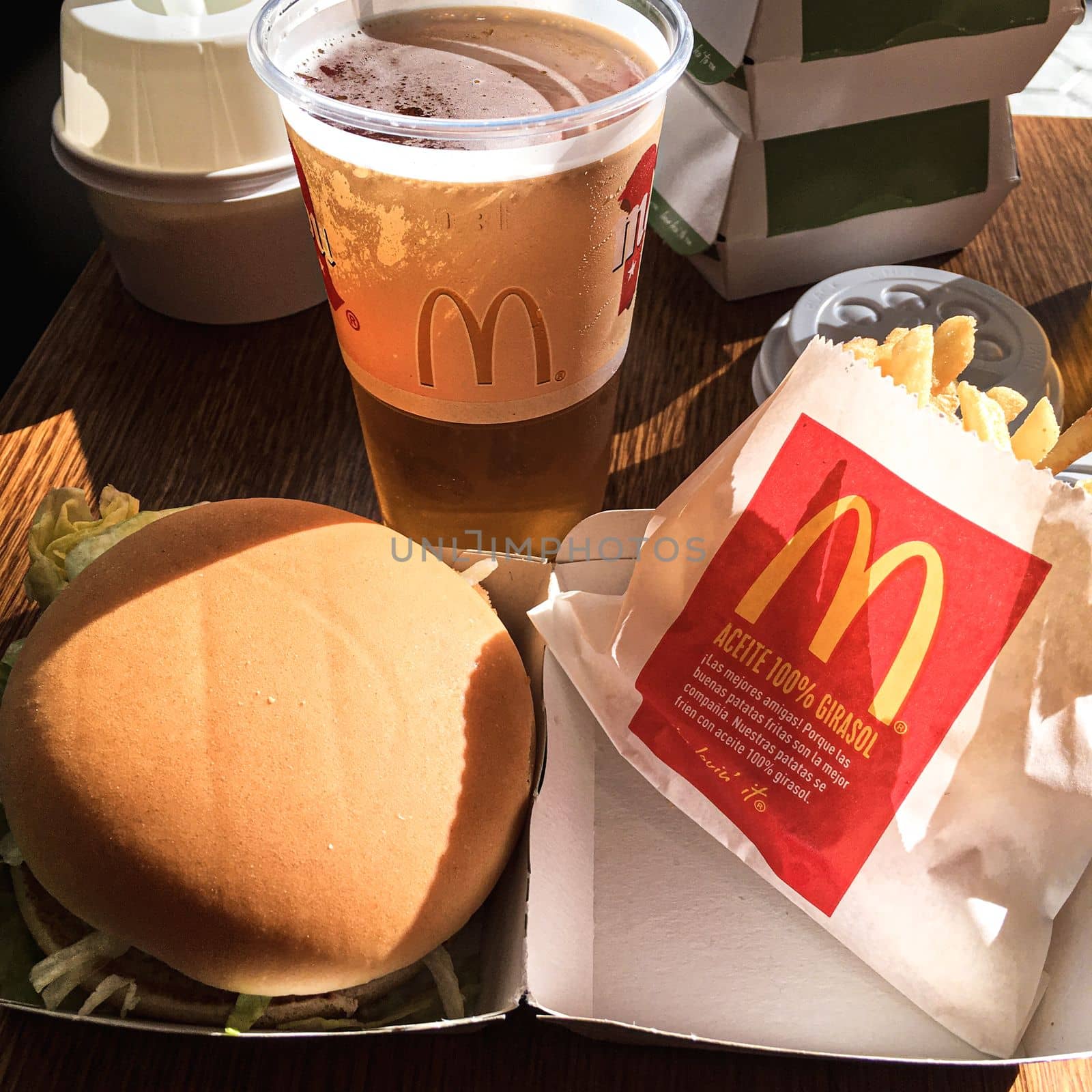 Mcdonalds burger with fries and a beer. Barcelona spain style mcdonalds. High quality photo