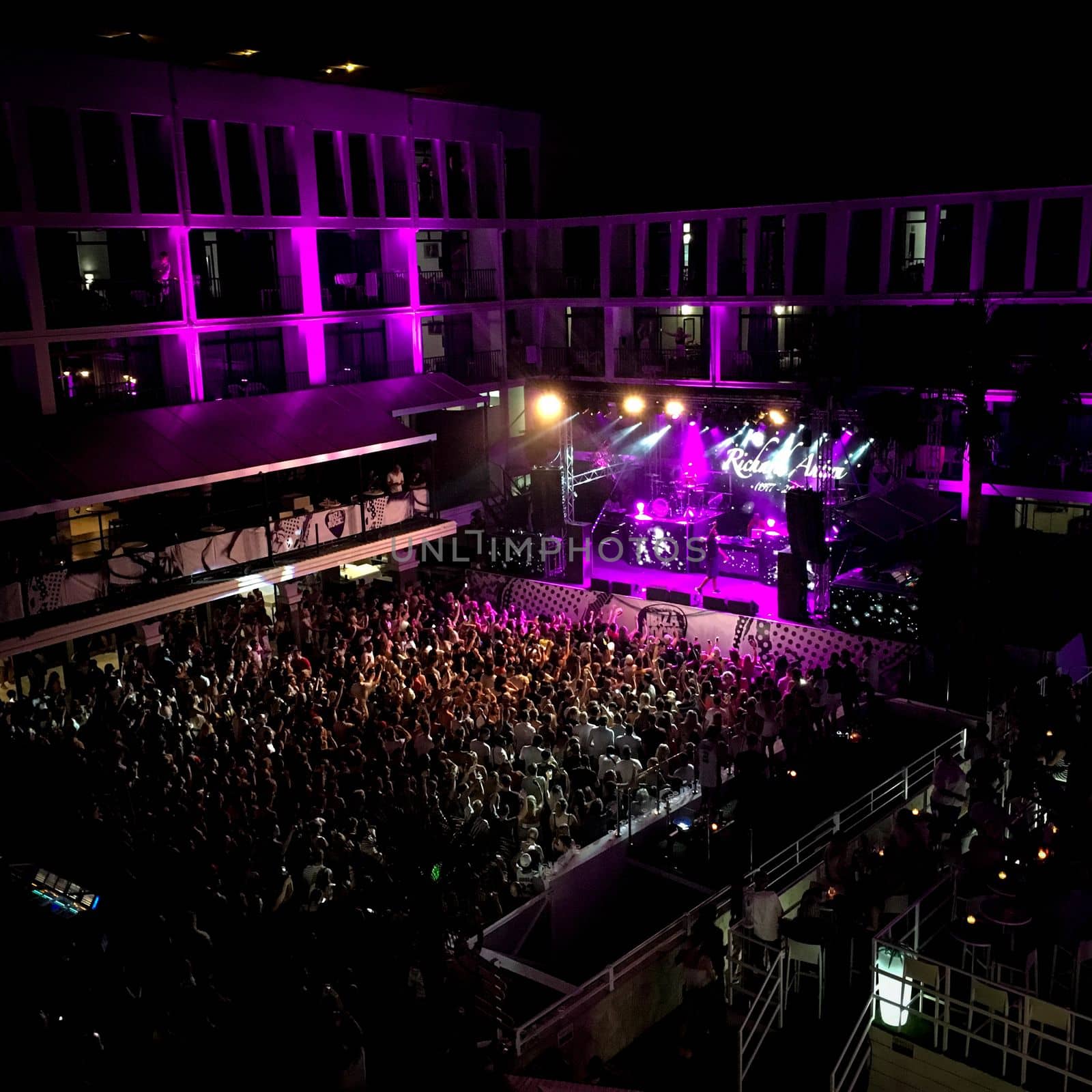 Nightclub in Ibiza with a crowd of people and a DJ. High quality photo