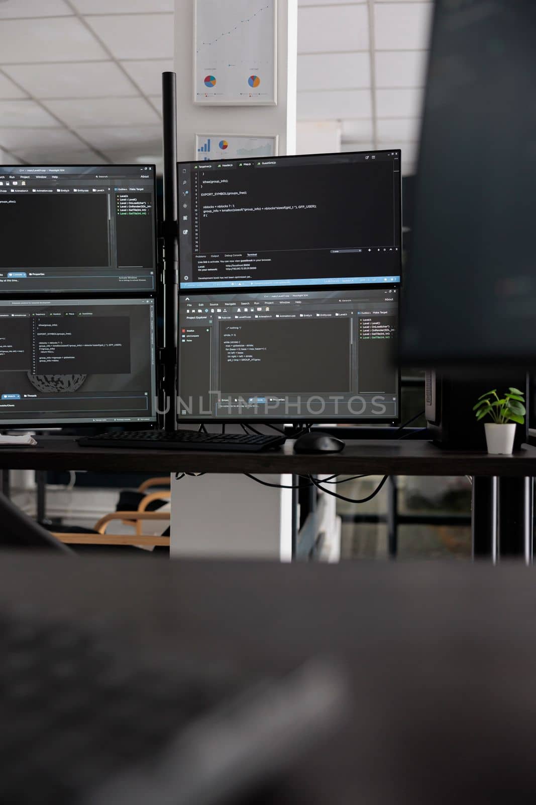 Computer screens showing compiling html code in empty developing office, security system parsing data algorithms in background. Artificial intelligence servers cloud computing in big data agency.