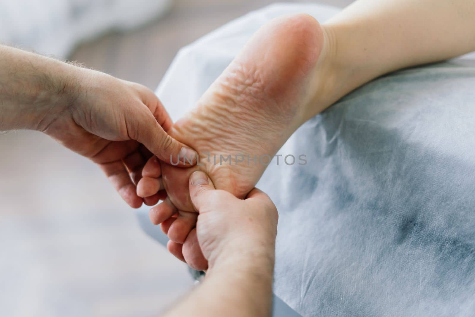 Young fat woman getting massage treatment in a day spa cabinet.