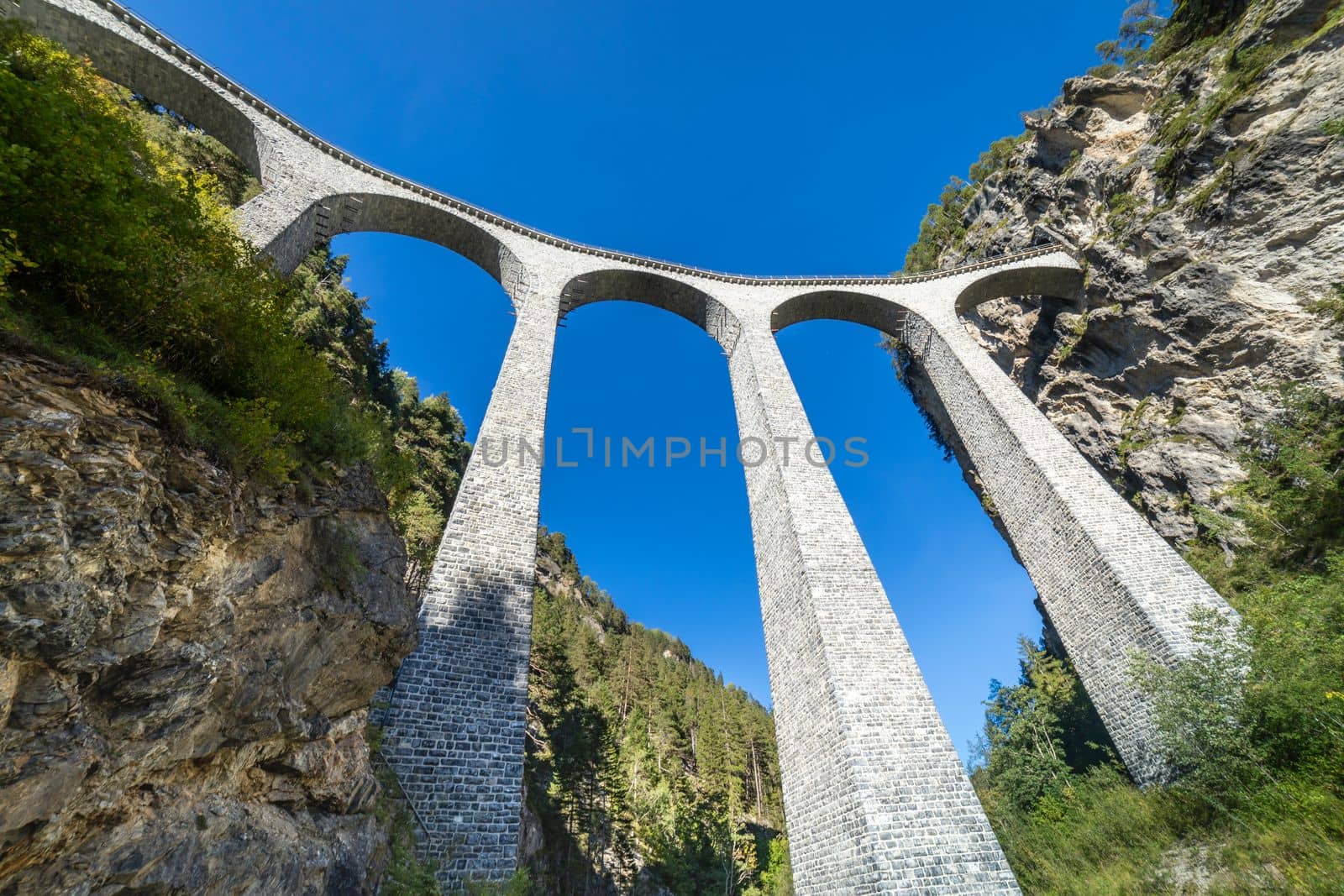 Swiss train over Landwasser Viaduct bridge in the alps, Graubunden valley, Switzerland