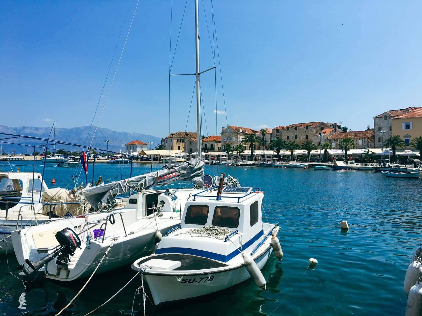 Brac Island Croatia in the middle of summer. With boats and people enjoying summer in the sandy bay.  by WeWander