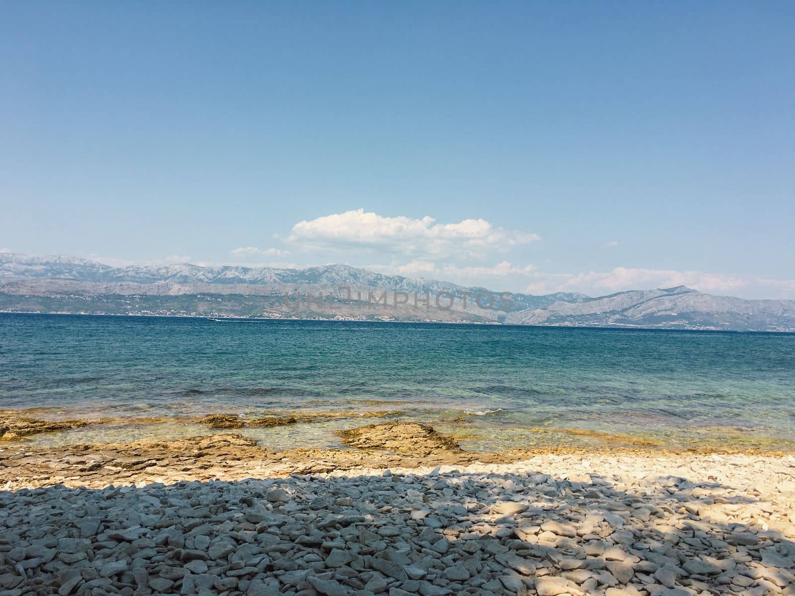 Brac Island Croatia in the middle of summer. With boats and people enjoying summer in the sandy bay.  by WeWander