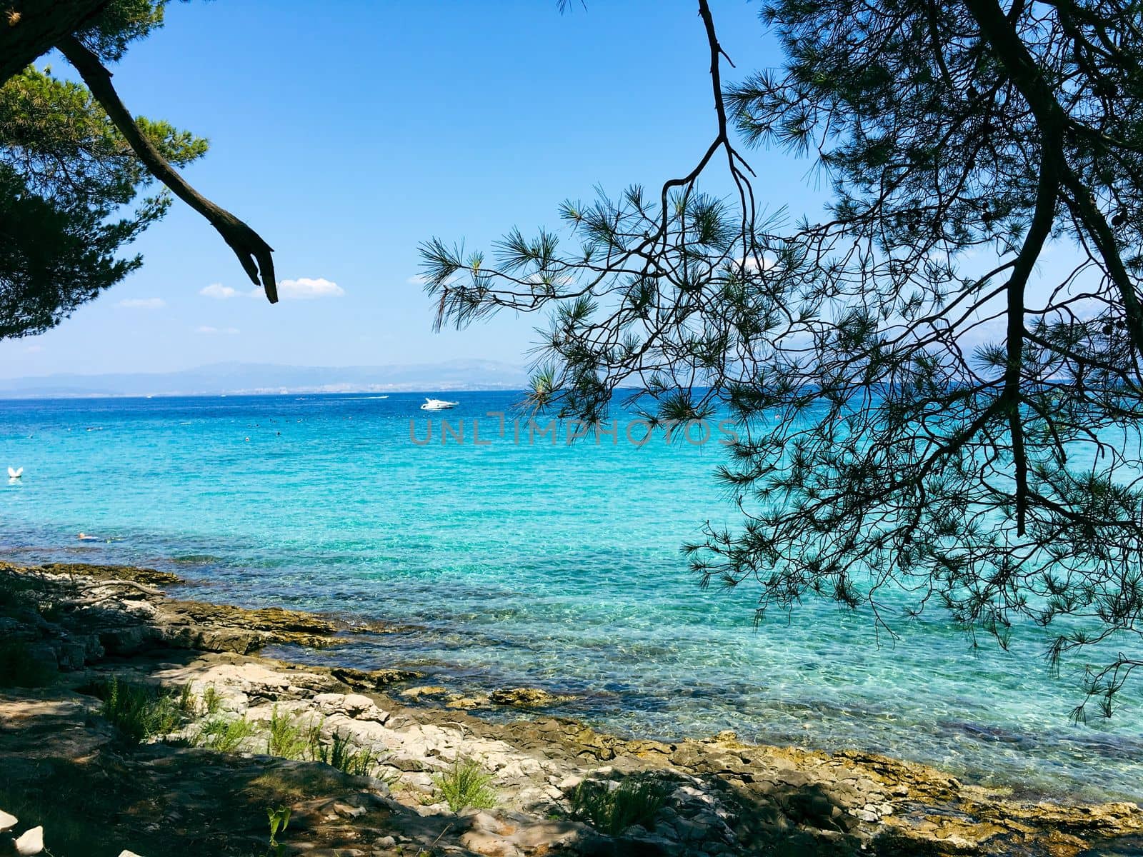 Brac Island Croatia in the middle of summer. With boats and people enjoying summer in the sandy bay.  by WeWander