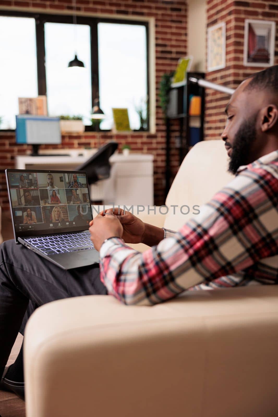 Business man talking to people on videocall conference, attending online meeting on teleconference. Chatting on remote videoconference call with webcam and laptop, working remotely.