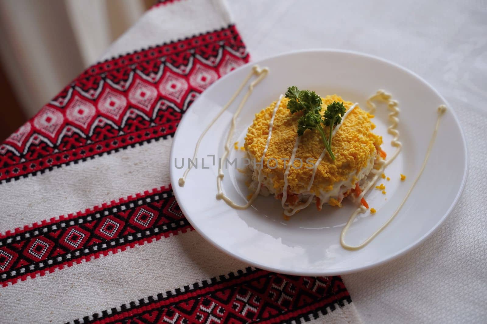 Traditional Ukrainian food on the table with embroidered tablecloth.