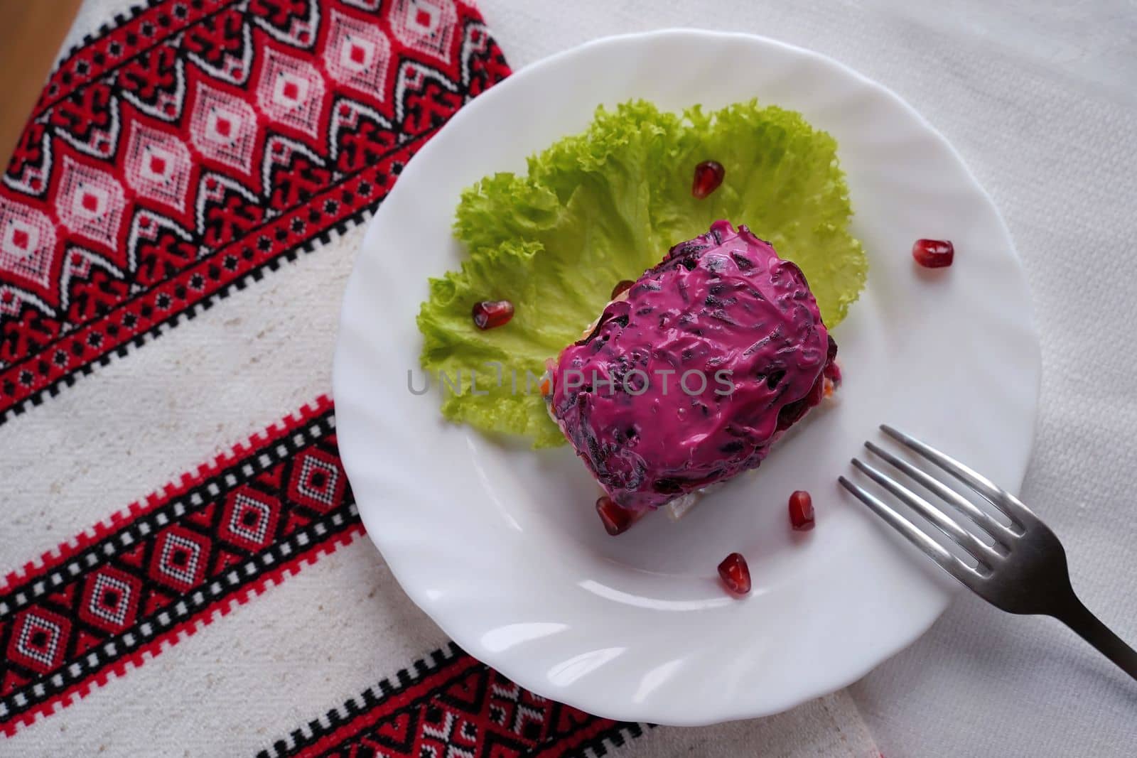 Traditional Ukrainian food on the table with embroidered tablecloth.