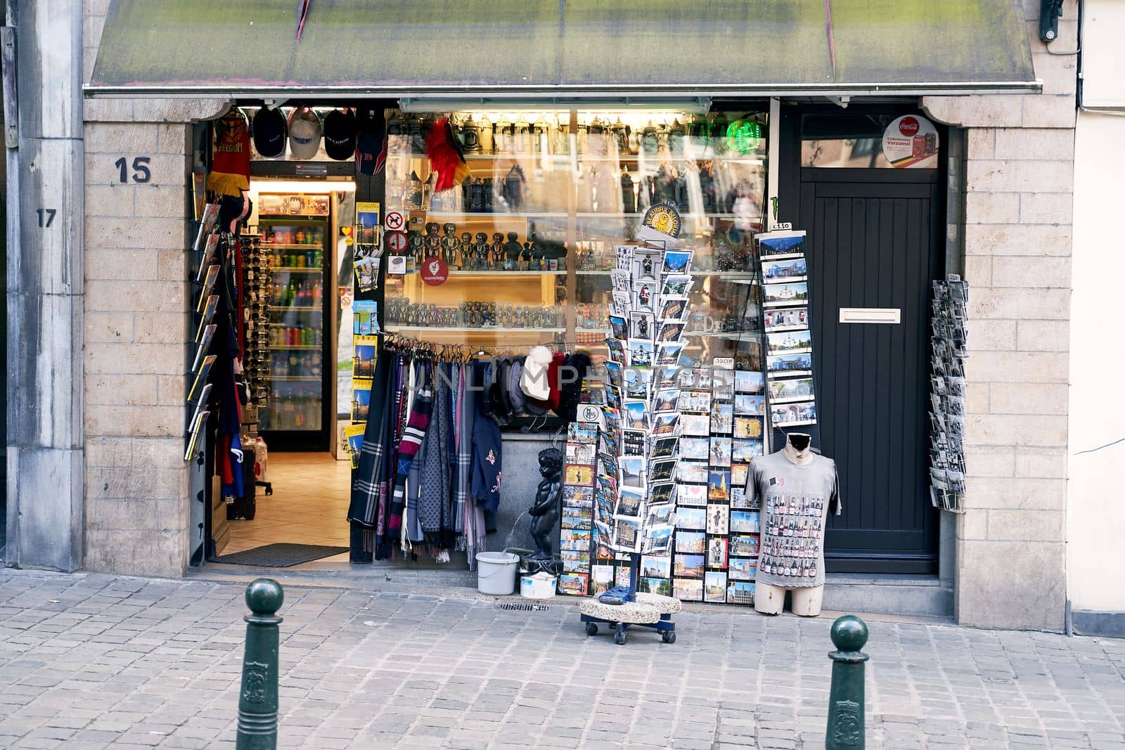 Brussels, Belgium, 4 April 2019 - Small street gift shop with many postcards, traditional souvenirs, food, and drinks.