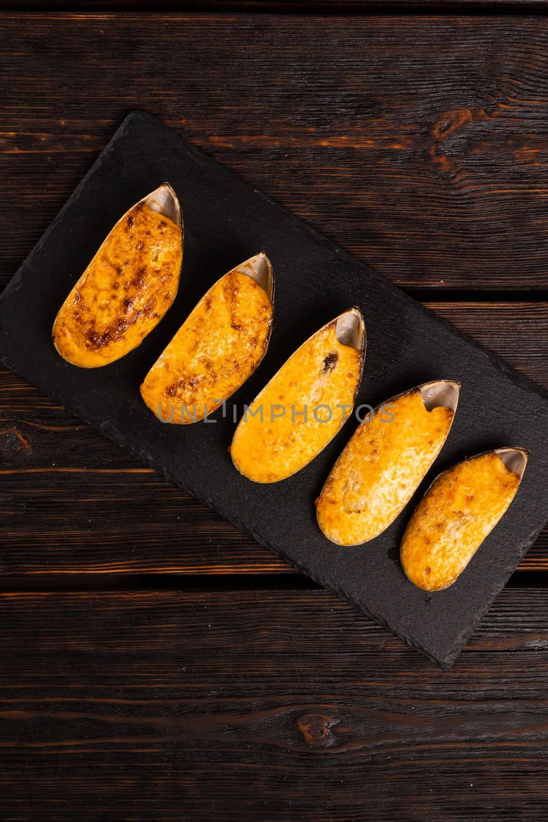 Fresh mussel baked with cheese top view - french or japanese cuisine.